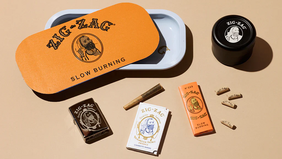 Modern smoking accessories from Zig-Zag including rolling tray, grinder, papers, and tips displayed on neutral background.