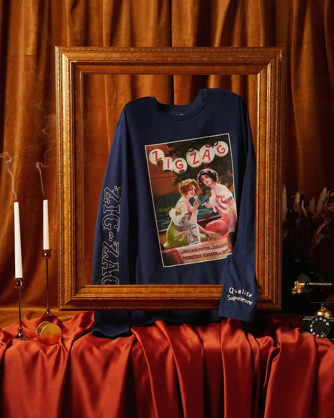 Zig-Zag long sleeve shirt in a frame featuring vintage artwork of two women and bold branding on the sleeve.