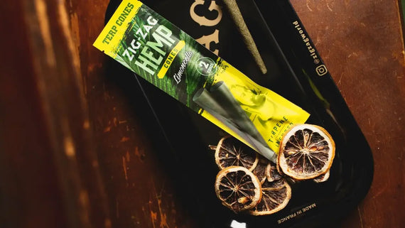 Terpene hemp cones in Zig-Zag Limoncello packaging with tray and dried citrus garnish for flavor emphasis.