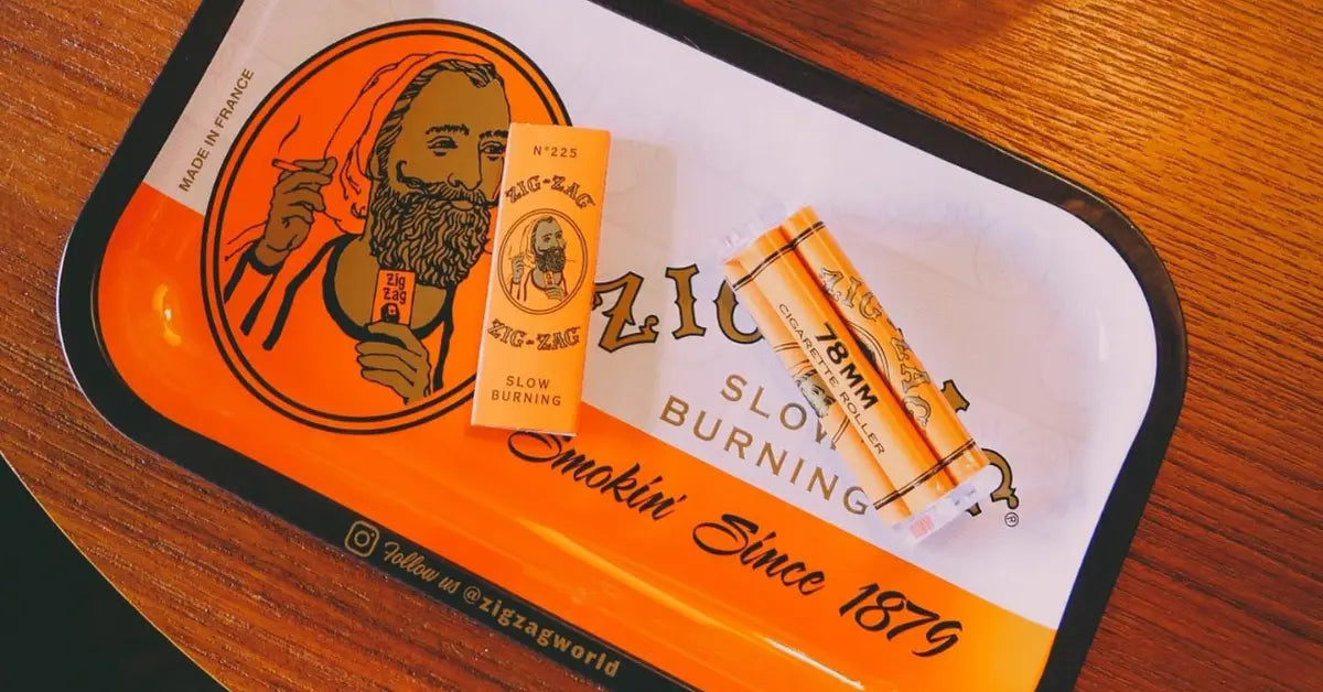 Top-rated smoking accessories including Zig-Zag slow burning papers and a 78mm roller on a branded orange tray