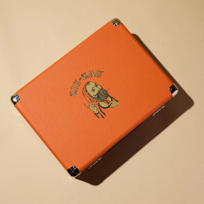 Zig-Zag record player in bright orange case featuring the classic bearded logo and metal corner protectors.