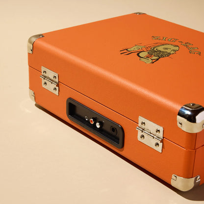 Zig-Zag record player with orange leather-style casing and audio output ports on the back panel.