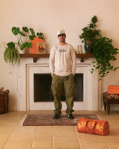 Zig-Zag long sleeve t-shirt featuring a small front logo, styled with olive cargo pants and a white cap.
