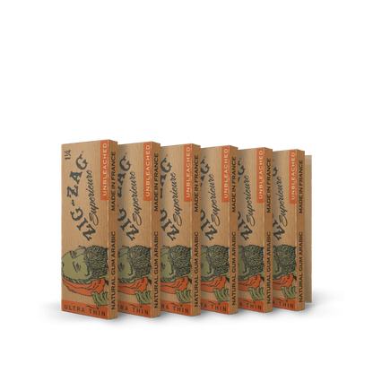 Unbleached thin rolling papers from Zig-Zag displayed in natural brown packs with black and orange text.
