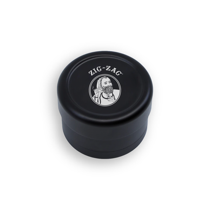 Zig-Zag grinder with a compact black design featuring the iconic Zig-Zag logo on the lid.