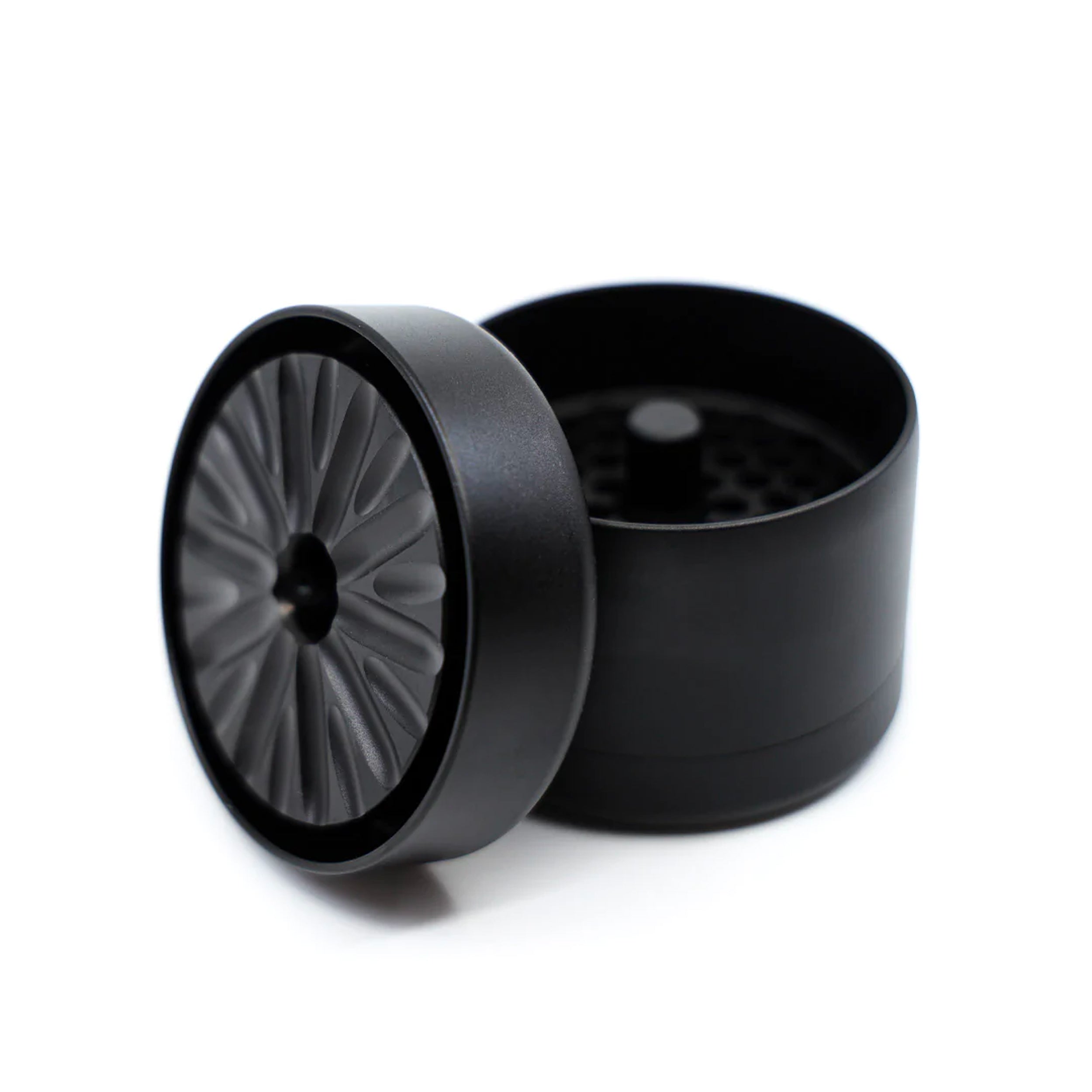 Black grinder with a fan-blade textured lid and spacious interior for efficient grinding.